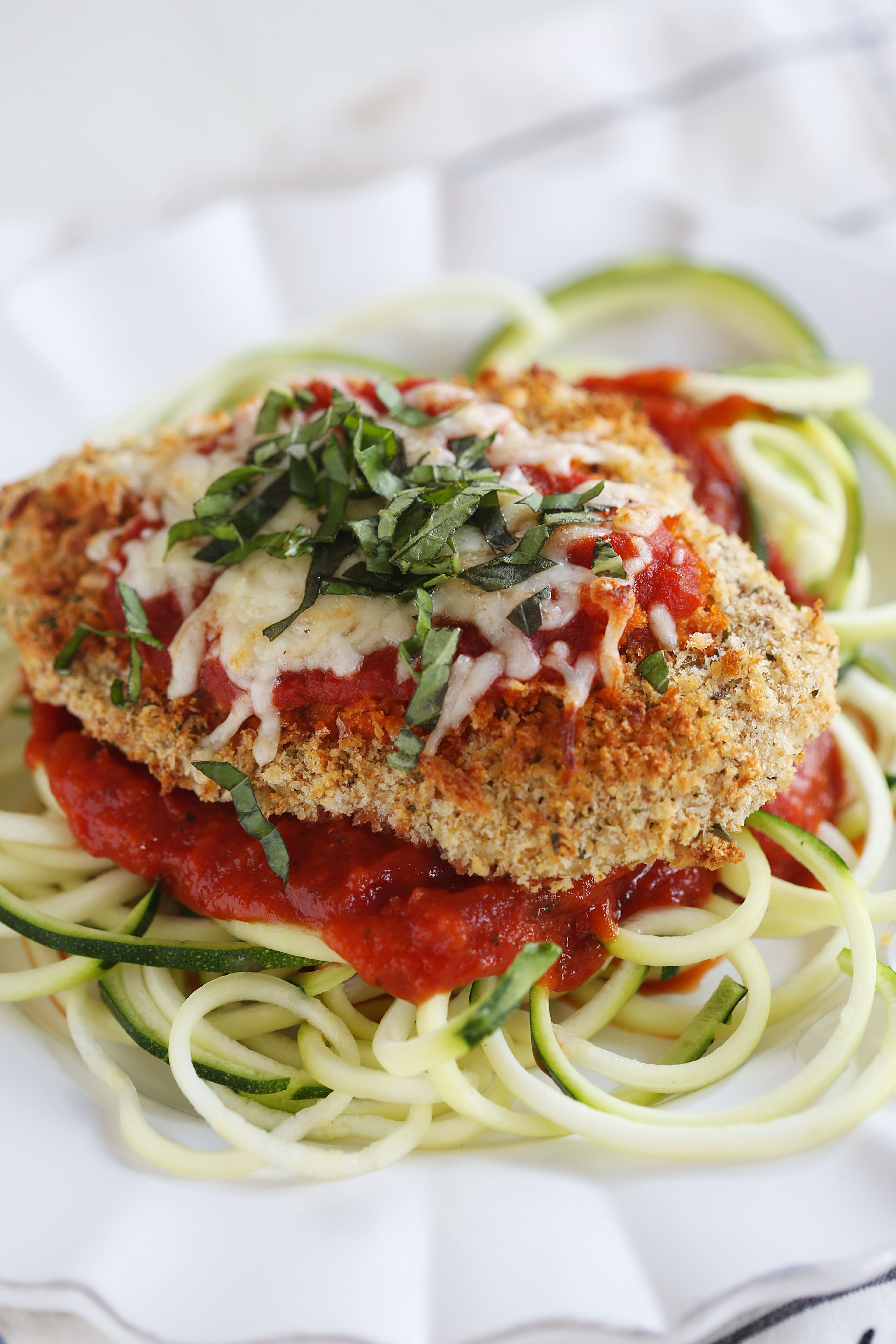 This recipe for Baked Chicken Parmesan with Zucchini Noodles is healthy, delicious and can easily be made in just 30 minutes or less!