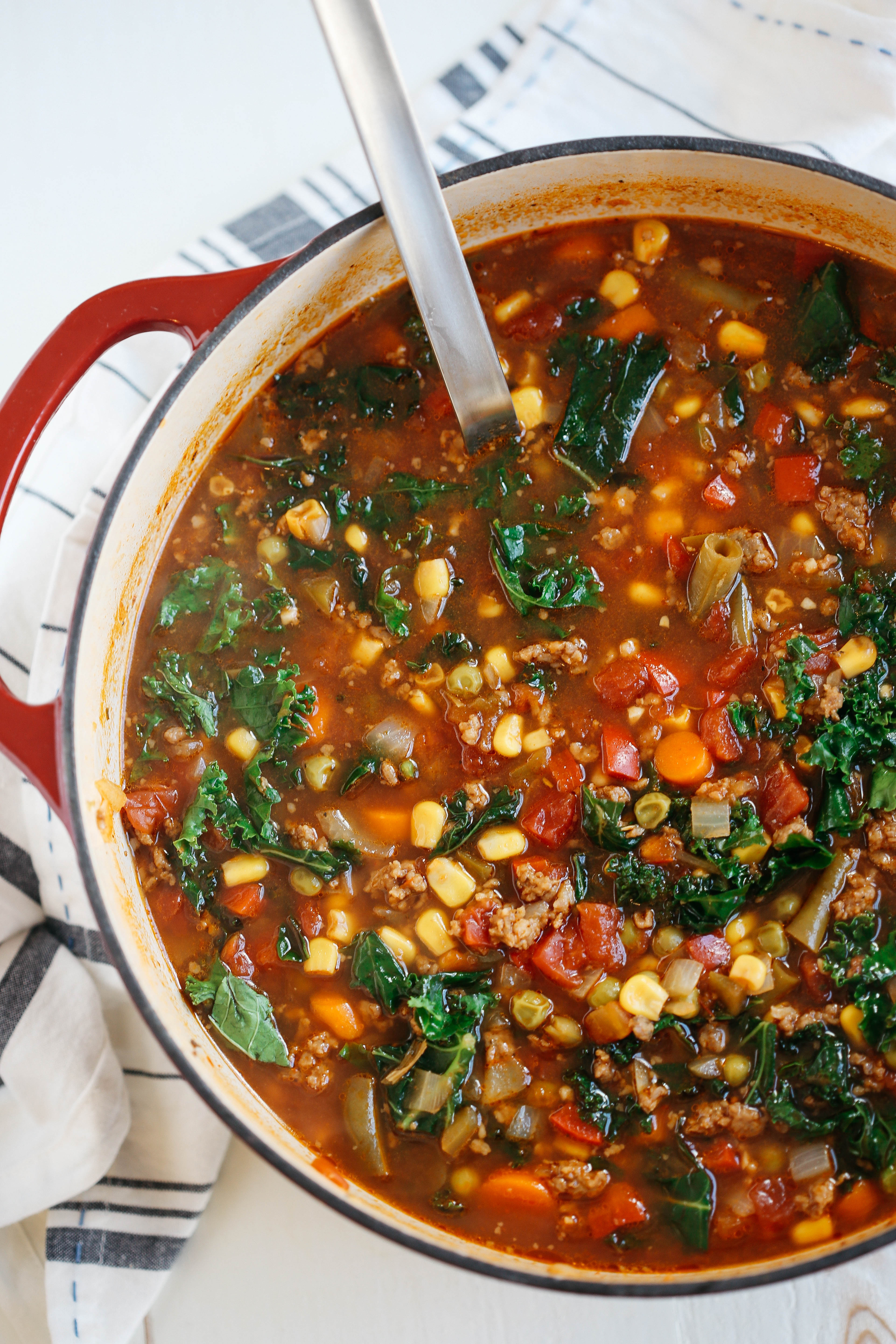 This One Pot Spicy Sausage and Kale Soup is hearty, delicious and literally takes just 5 minutes to throw together in a pot or slow cooker!